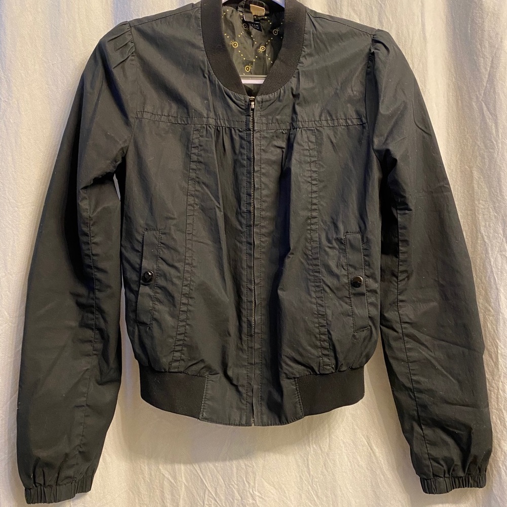 Black fitted zip up sport jacket.